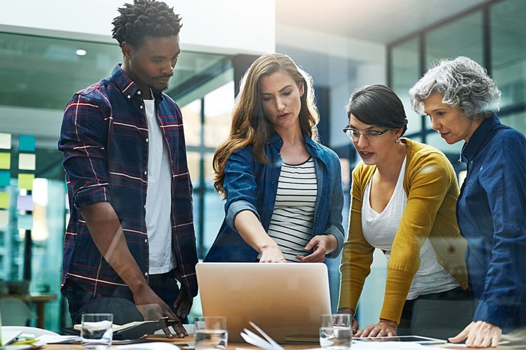 Three people looking at a computer screen together
