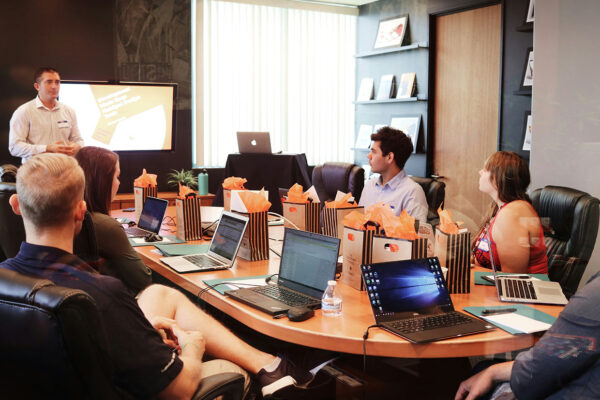 Image of professionals sitting around a table