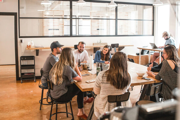 Team of professionals sitting around a large table