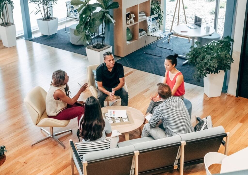 Group of professionals sitting around an informal table talking