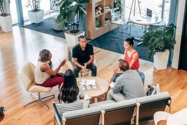 Group of professionals sitting around an informal table talking