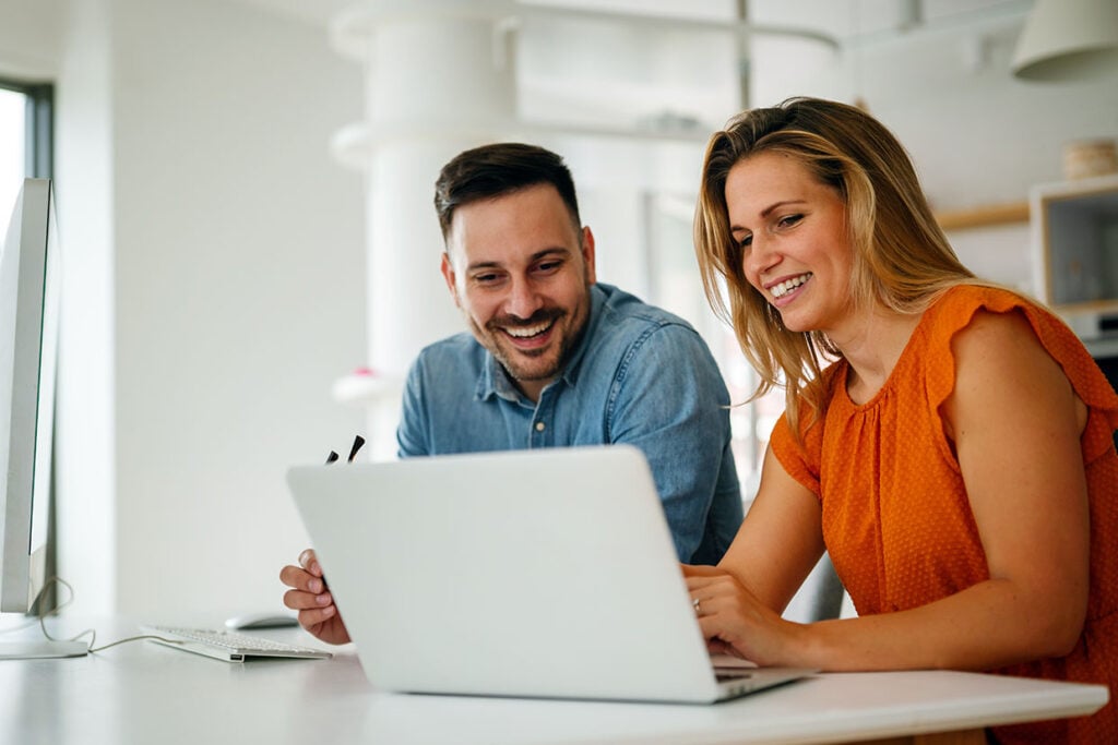colleagues looking at laptop