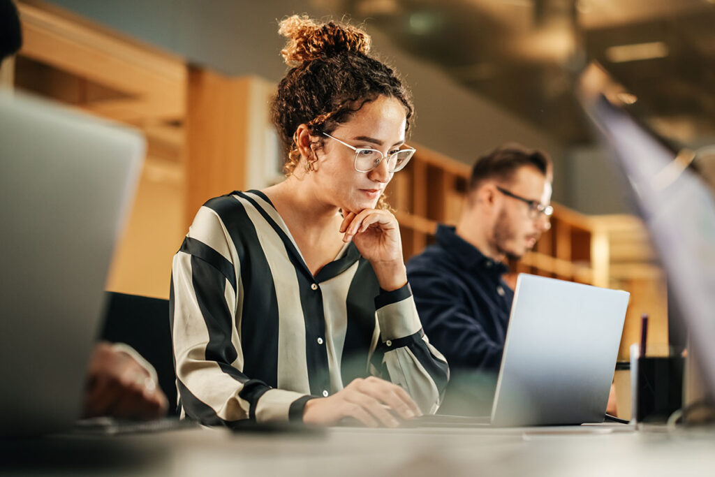 young professional looking at laptop